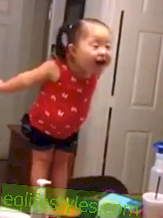 Cute: Little girl with Down Syndrome is dancing in front of the mirror